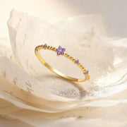 14k gold filled ring with purple gemstones and a five-petal flower design